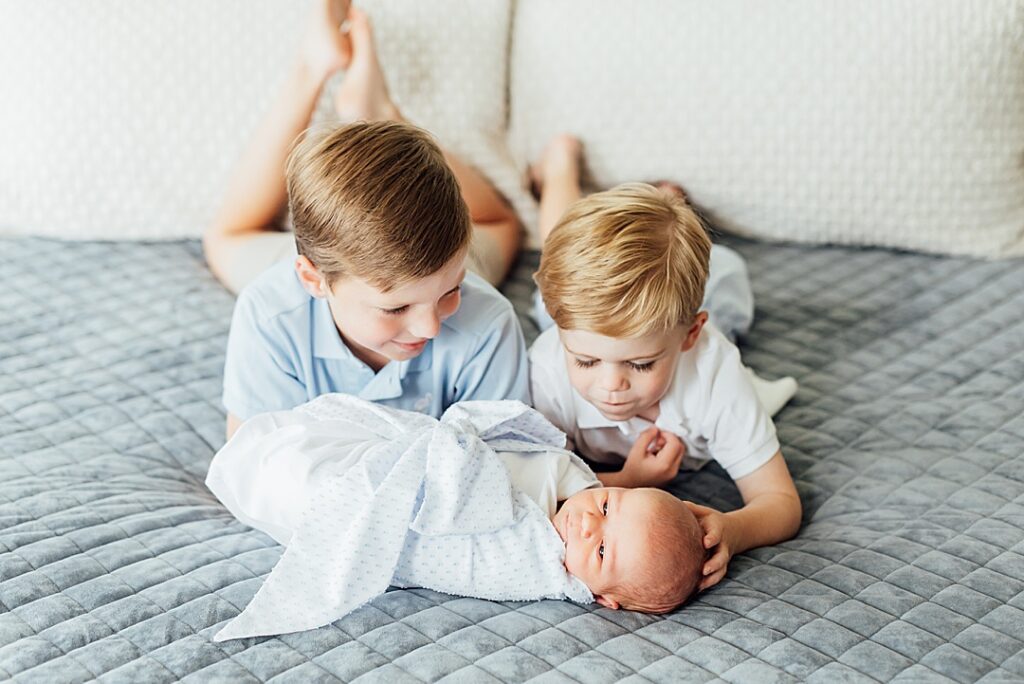 Newborn baby boy with big brothers