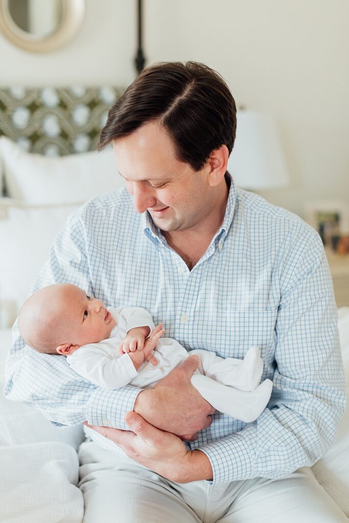Dad admiring baby boy.
